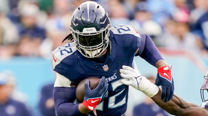 Titans running back Derrick Henry goes past a defender with the ball.